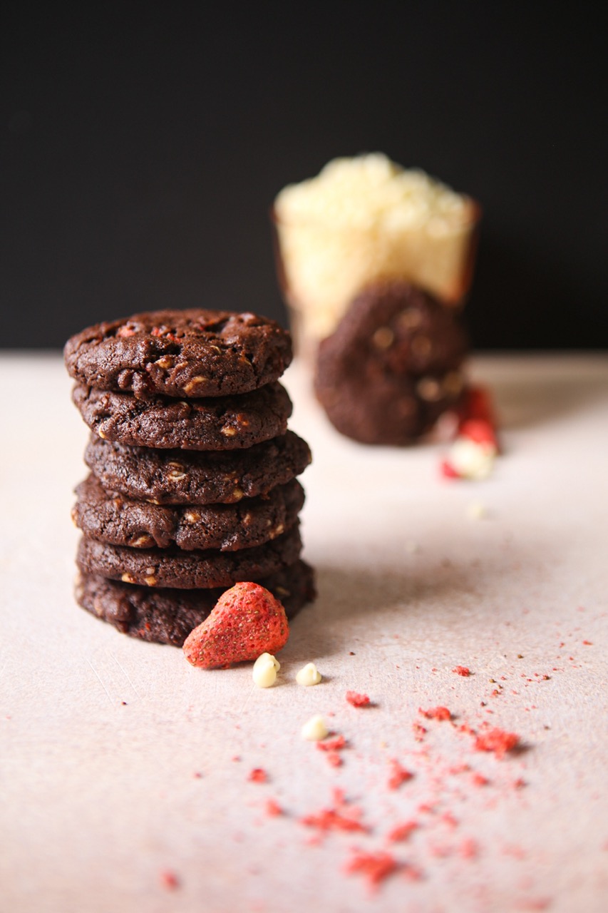 white chocolate strawberry chocolate cookies stacked with crumbled strawberries