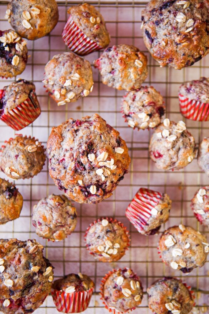 Healthy triple berry ginger oat muffins on a cooling rack
