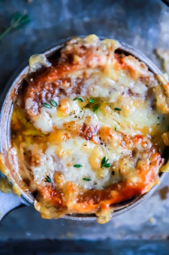 Closeup of french onion soup with crispy melted gruyere